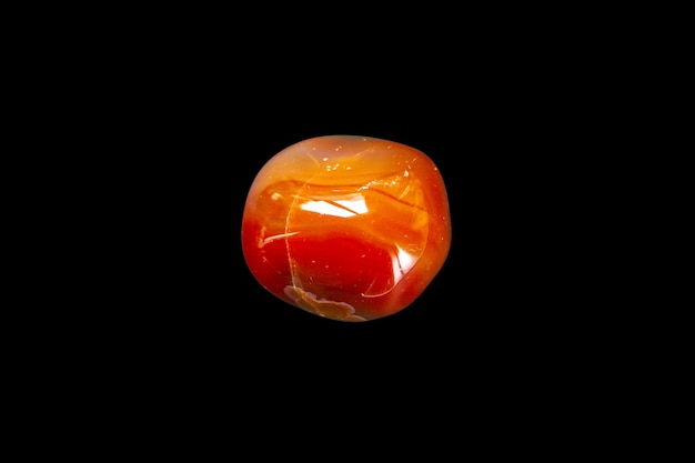 Carnelian agate gemstone isolated on a black background