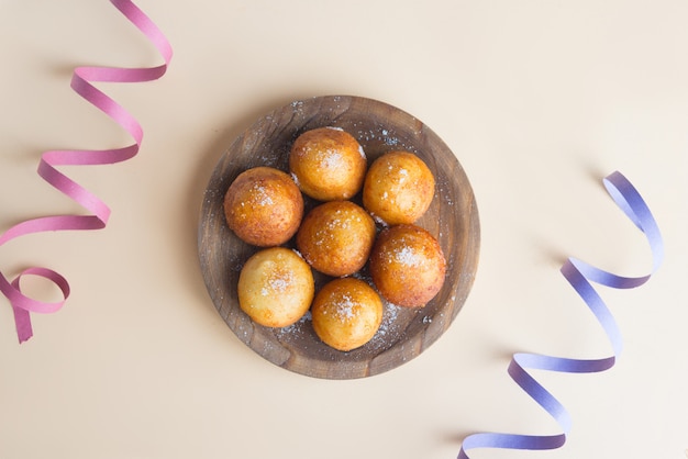 Carnival italian fritters in carnival on brown background