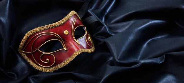 Carnival mask Venetian handmade mask on black satin background banner