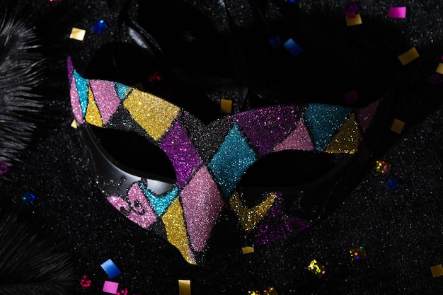 Photo carnival mask with glitters on black background