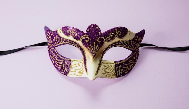 Carnival Venetian purple color with glitter on vibrant pink background female disguise masquerade