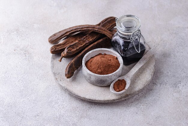 Carob pods powder and molasses or syrup