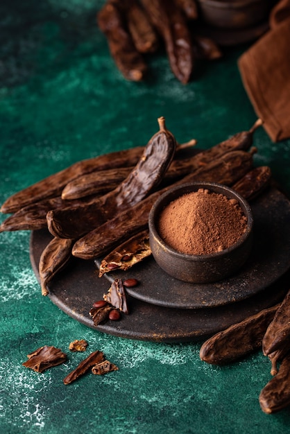 Photo carob pods powder and molasses or syrup