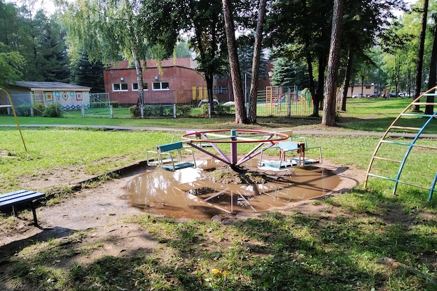 Carousel on the playground in a puddle