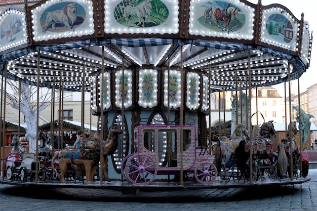 A carousel with a pink carriage and a pink horse on it