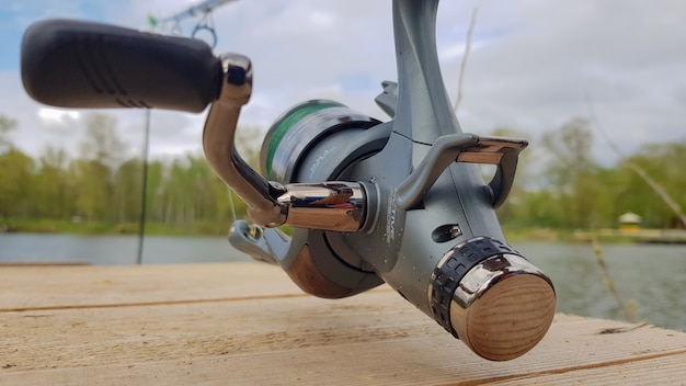 Carp fishing rod isolated on the lake and wooden bridge