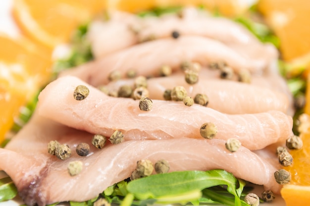 Carpaccio of fresh Mediterranean swordfish with green pepper, chives and a few drops of orange juice