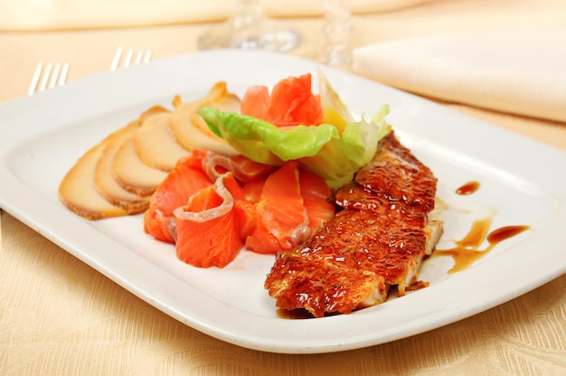 Carpaccio of salmon and other fish on a dish in restaurant