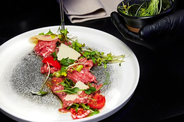 Carpaccio with arugula and parmesan in the restaurant