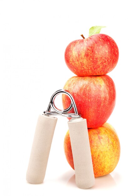 Carpal expander and a stack of three red apples