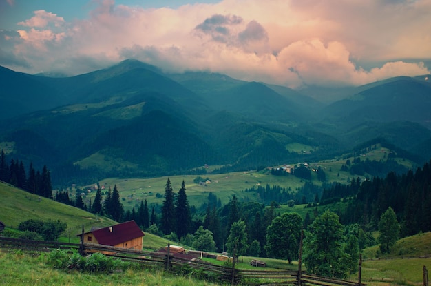 Carpathian mountains summer landscape with cloudy sky and village natural summer travel background