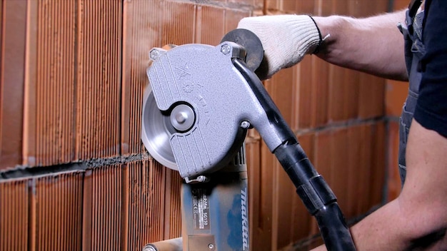 Carpenter cutting with grinder stock footage closeup of professional worker making cuts in brickwork