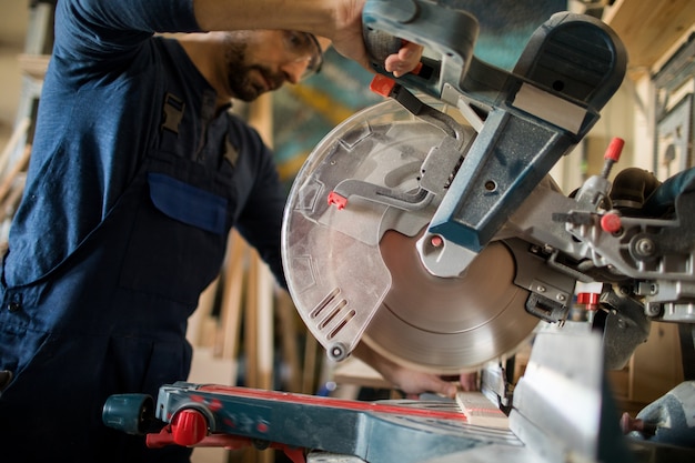 Carpenter Cutting Wood Closeup