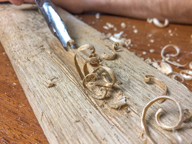 Carpenter does his job, wood processing by hand.