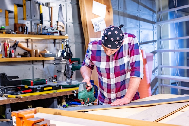 Carpenter doing his job in carpentry workshop