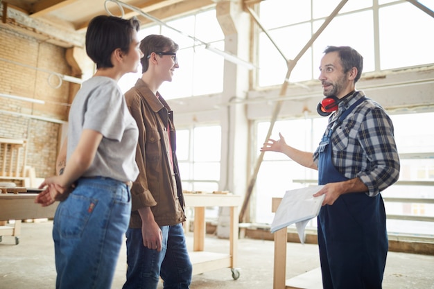 Carpenter Giving Tour of Factory