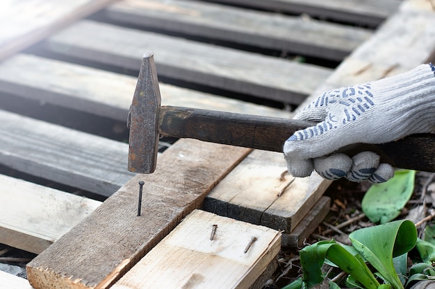 A carpenter hammering a nail