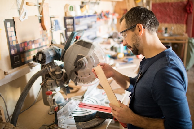 Carpenter Inspecting Materials