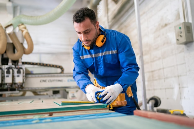 Carpenter making furniture in workshop