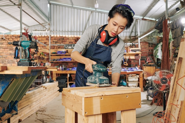 Carpenter polishing wooden surface