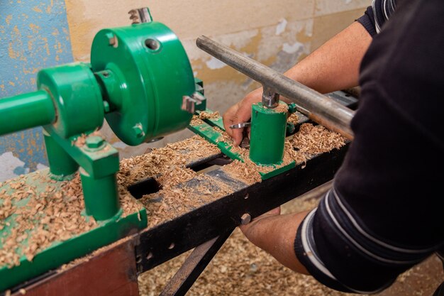 Carpenter preparing machine for turning wood on a lathe