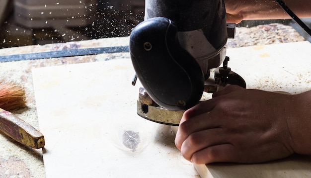 carpenter processes wood on a machine