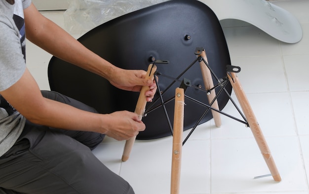 Carpenter putting together parts of chair