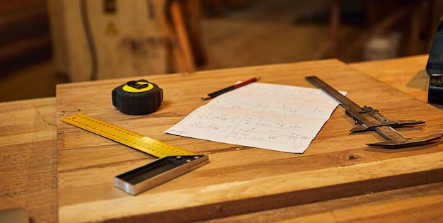 Carpenter's pencil tape measure square and carpentry drawings on the workshop