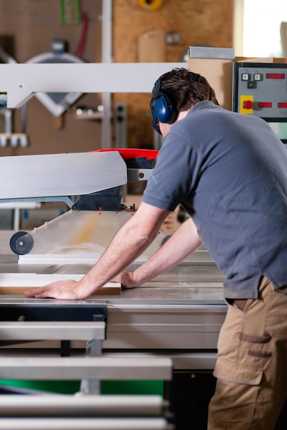 Carpenter using electric saw