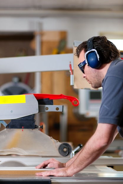 Carpenter using electric saw