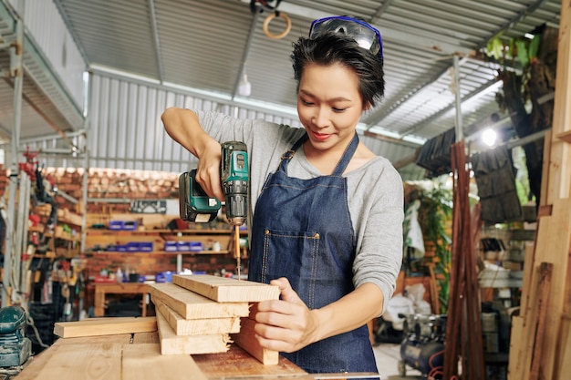 Carpenter using electric screwdriver