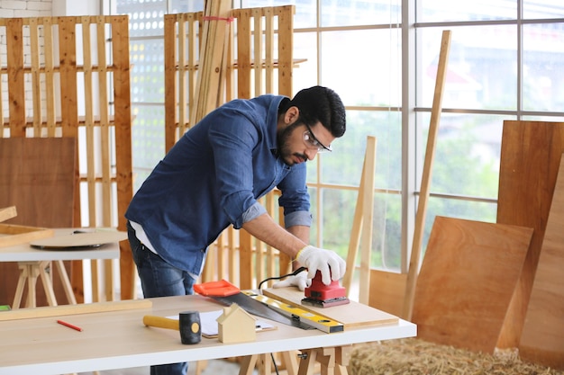 carpenter or warehouse worker choosing raw wood material for the work at the carpentry storage