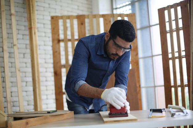 Carpenter or warehouse worker choosing raw wood material for the work at the carpentry storage