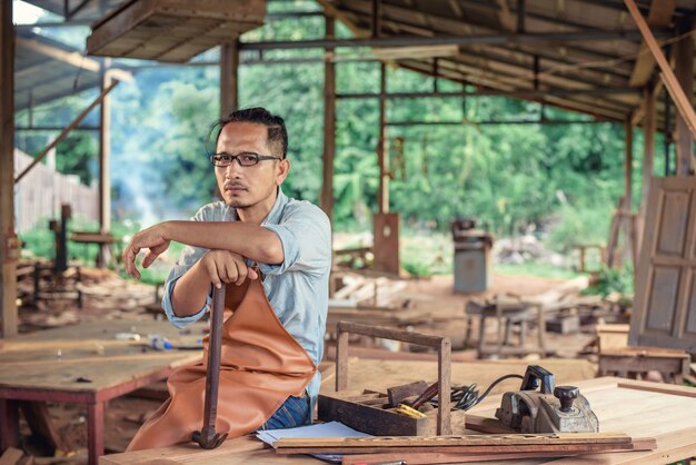 Carpenter Woodwork and furniture making in carpentry workshop