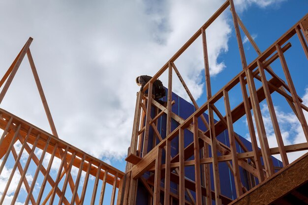 Carpenter at work with wooden roof construction wood building frame