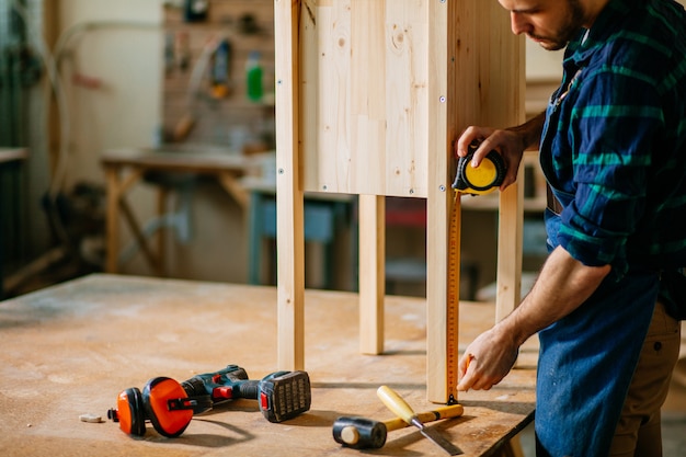 Carpenter working in his woodwork or workshop