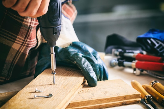 Carpenter working with an electric screwdriver