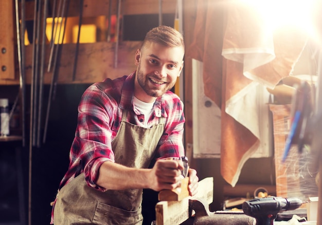 Photo carpenter working with plane and wood at workshop