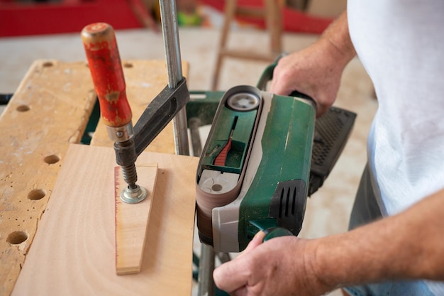 Carpenter working on wood craft at workshop to produce construction material or wooden furniture.