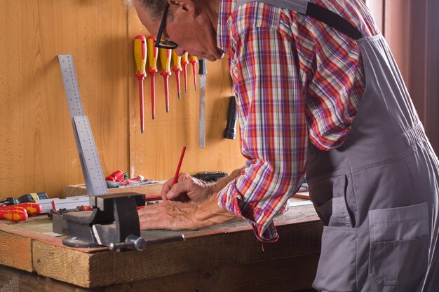 Carpenter working on the work bench joinery tools and woodwork