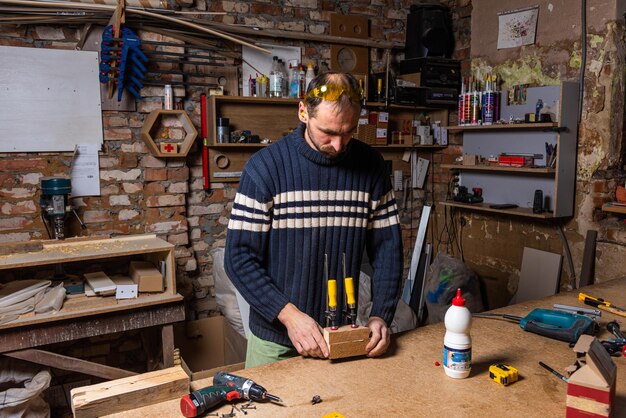 A carpenter works in a furniture workshop