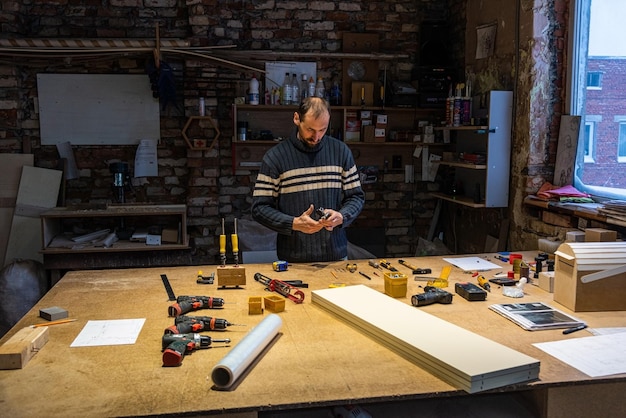 A carpenter works in a furniture workshop