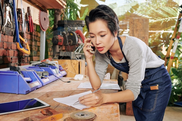 Carpenter writing down order details