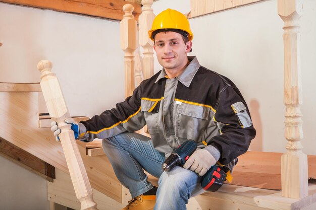 Carpentery worker sitting on ladder