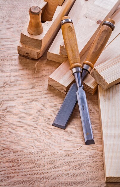 Carpentry chisels old woodworkers plane and planks on wooden board