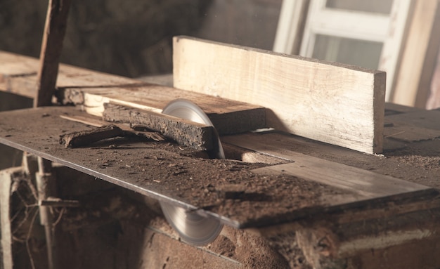 Carpentry machine with a piece of wood.