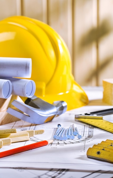 Carpentry tools on table with blueprints