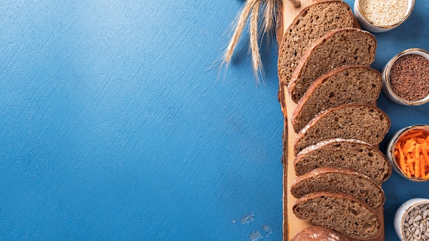 Carrot bread. Slices carrot bread with flax seeds, a sesame seed and  sunflower seeds. Healthy food. Dietary and vegan food.