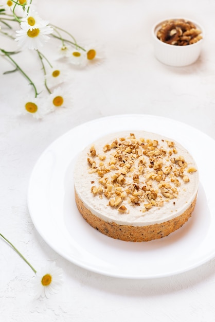 Carrot cake with walnuts on a white plate