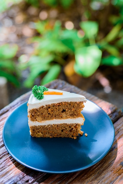 Carrot cake on a wooden table in the garden